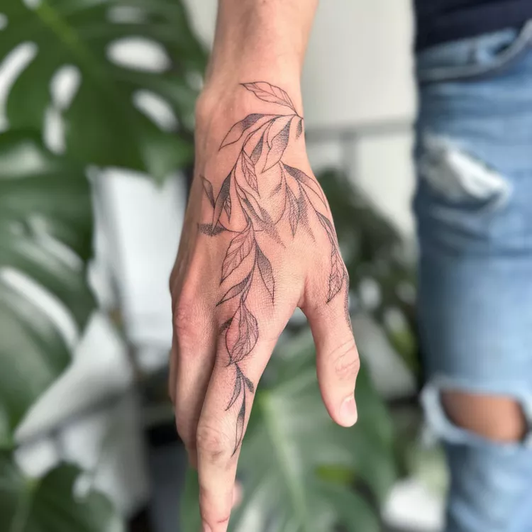 Sweeping Leaves Hand Tattoo
