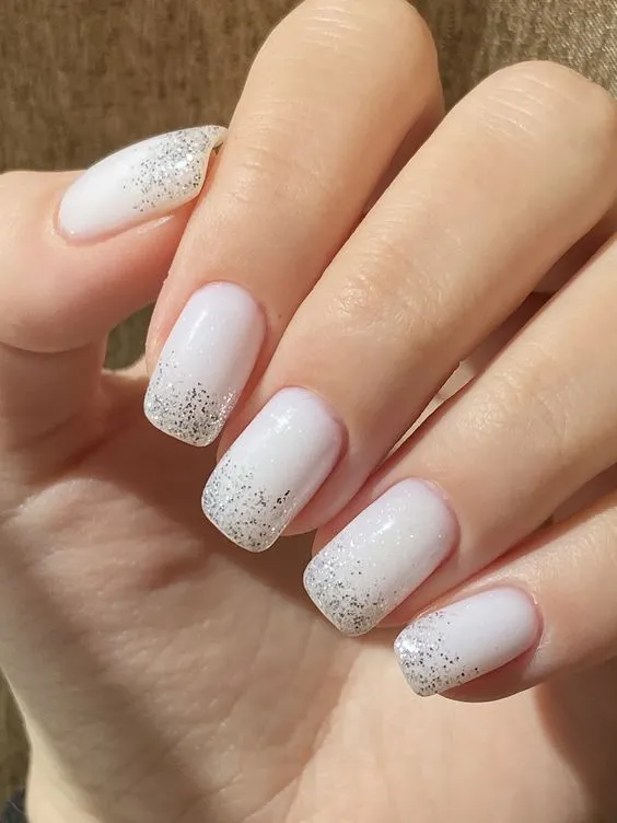 White nails with glitter ombre