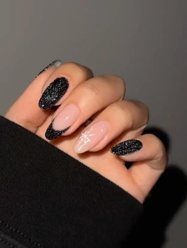 Sparkling black polish with white snowflakes nails